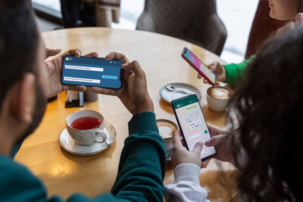 high angle friends holding smartphones