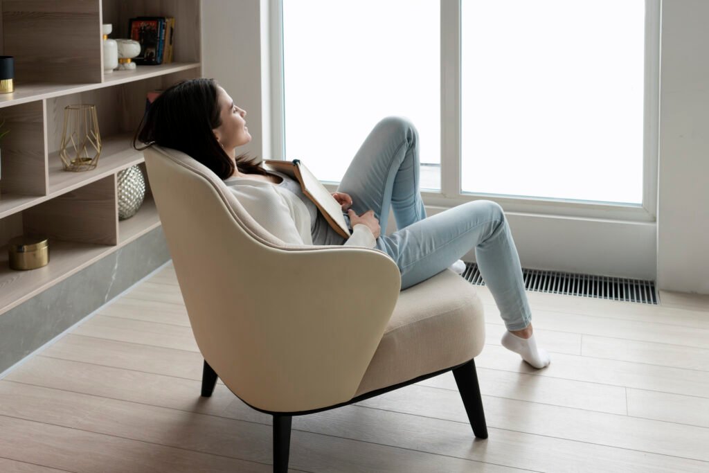 full shot woman with book chair